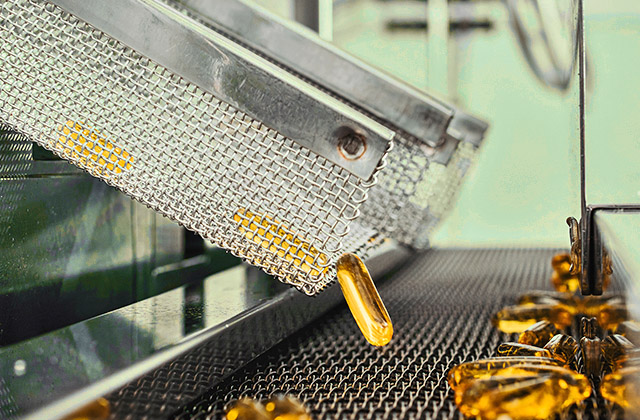 Capsules being sorted in a factory machine