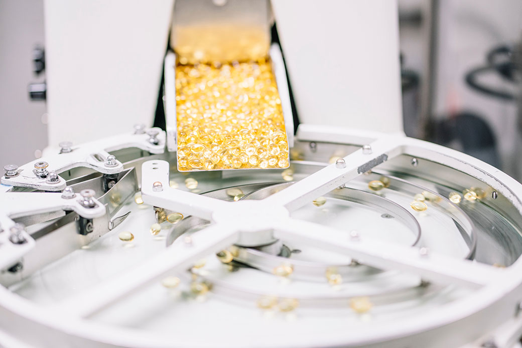 Capsules being sorted in a factory machine