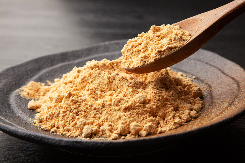 Powder being scooped by a wooden spoon